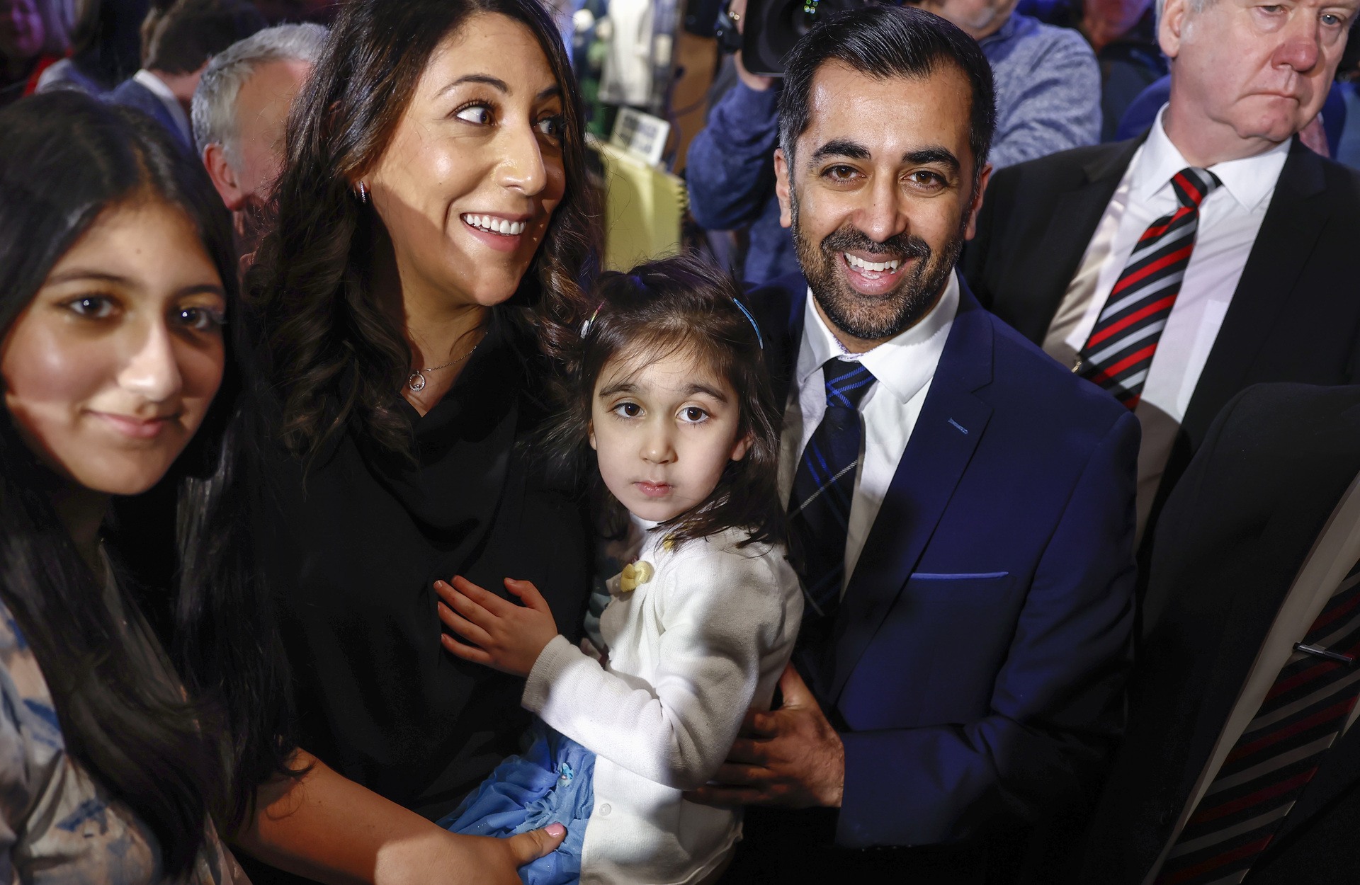 Scotland's Health Minister and SNP MSP, Humza Yousaf (R) with his wife Nadia El-Nakla (L) and daughter Amal (C) reacts after being elected as new SNP party leader, at Murrayfield on March 27, 2023.