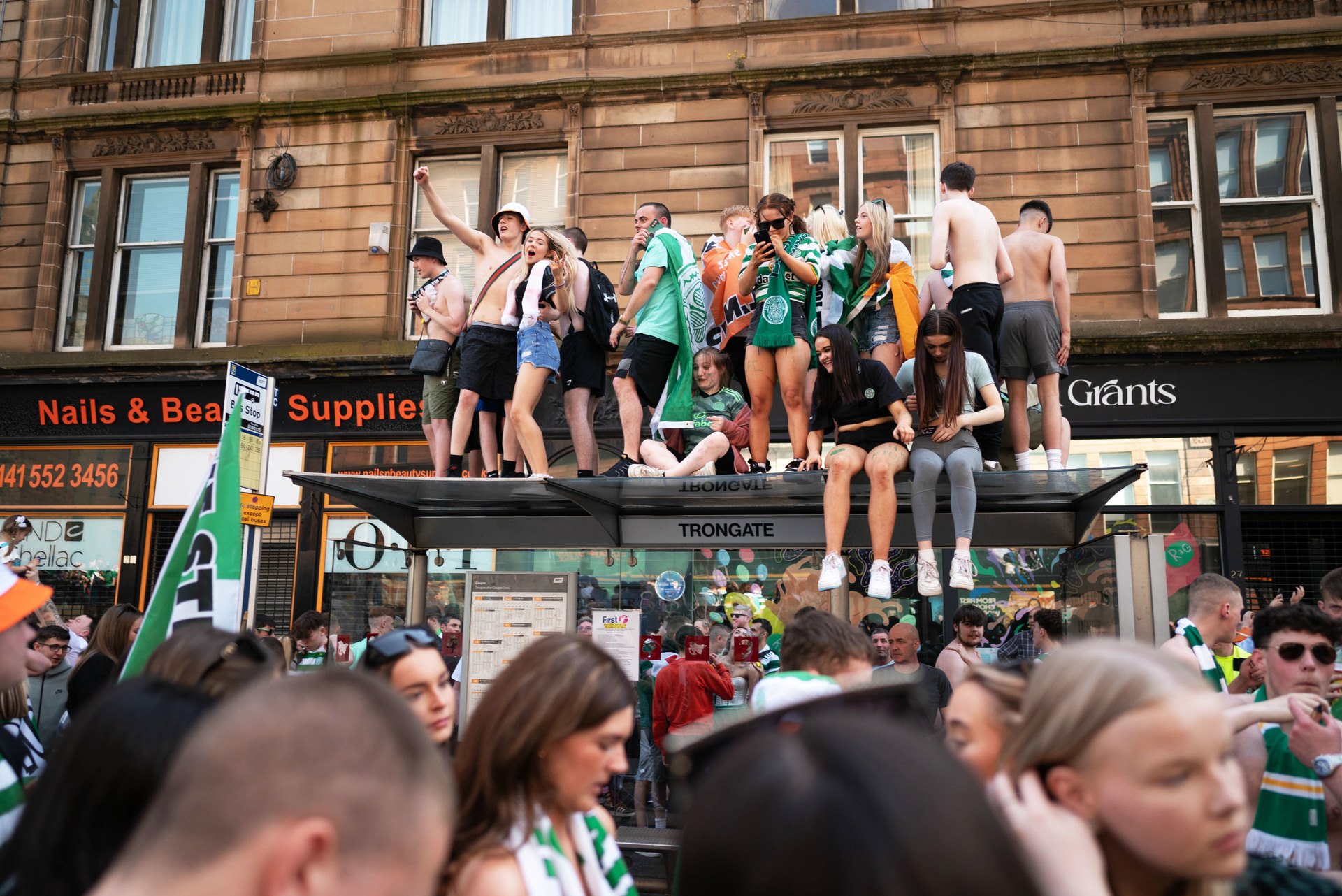 GLASGOW, SCOTLAND - MAY 18: Celtic fans are pictured as they celebrate winning the 2023/24 cinch Premiership title in Merchant City, on May 18, 2024, in Glasgow, Scotland.  (Photo by Ewan Bootman / SNS Group).