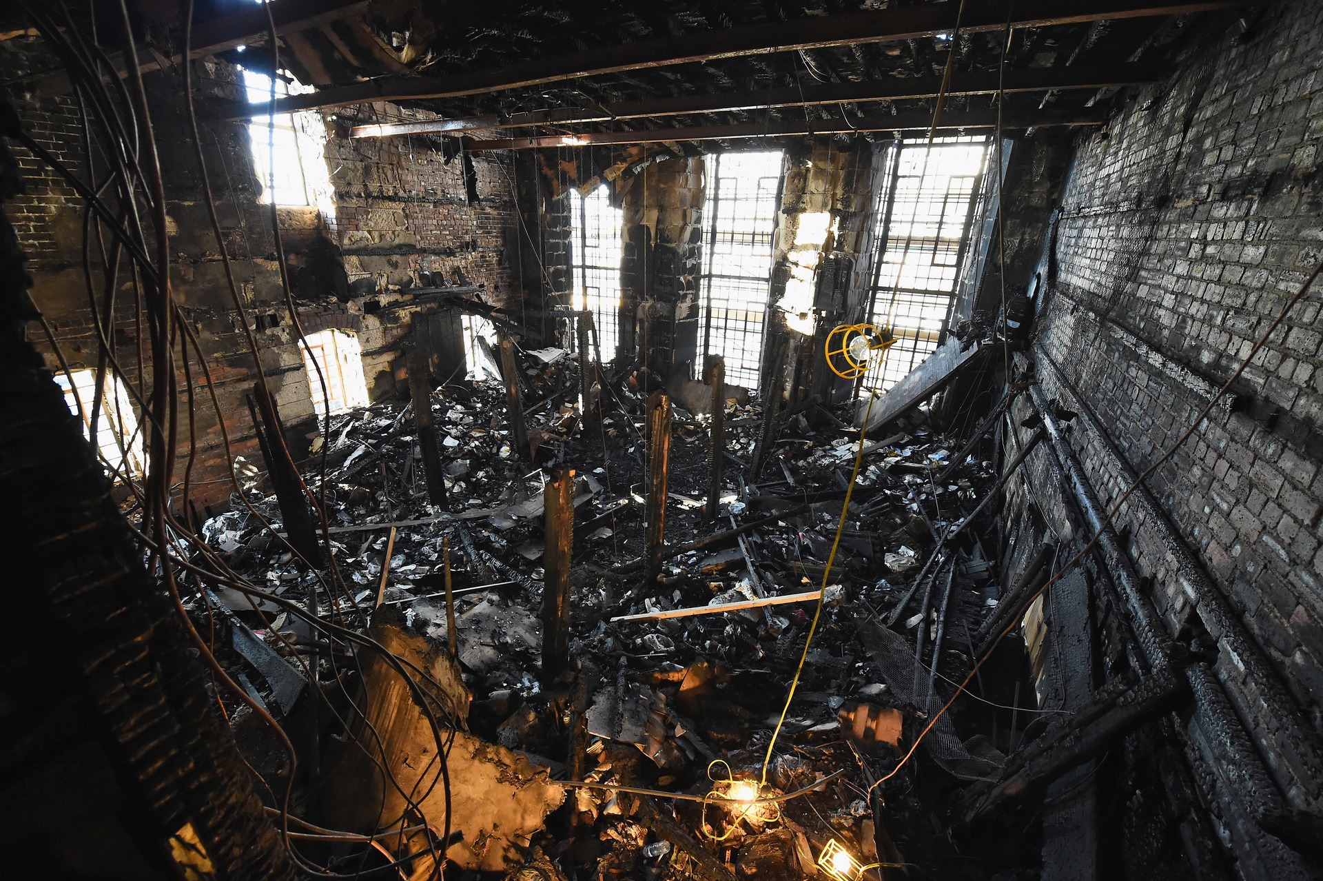 GLASGOW, SCOTLAND - NOVEMBER 18: Forensic archaeologists begin sifting through the ashes of the fire damaged Mackintosh Library at the Glasgow School of Art on November 18, 2014