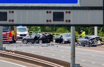 Officer and two other men still fighting for life after three-car M8 crash