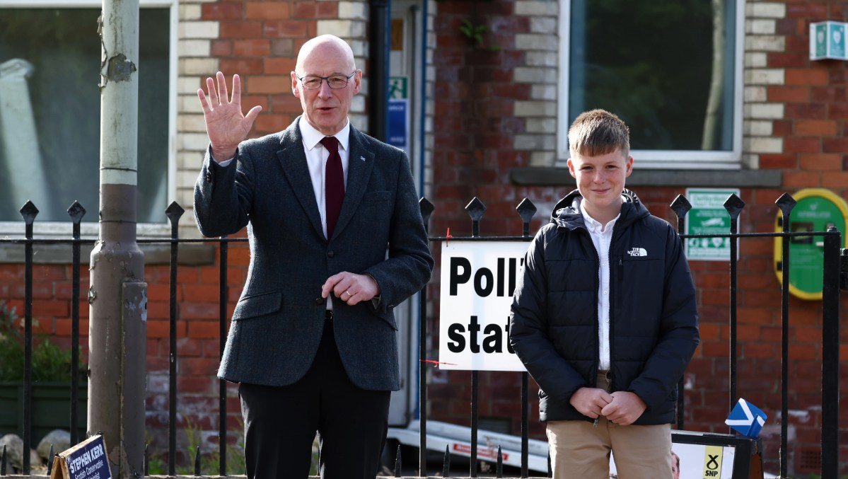 First Minister of Scotland, John Swinney, arrives to vote at a polling station with son Matthew in Blairgowrie.