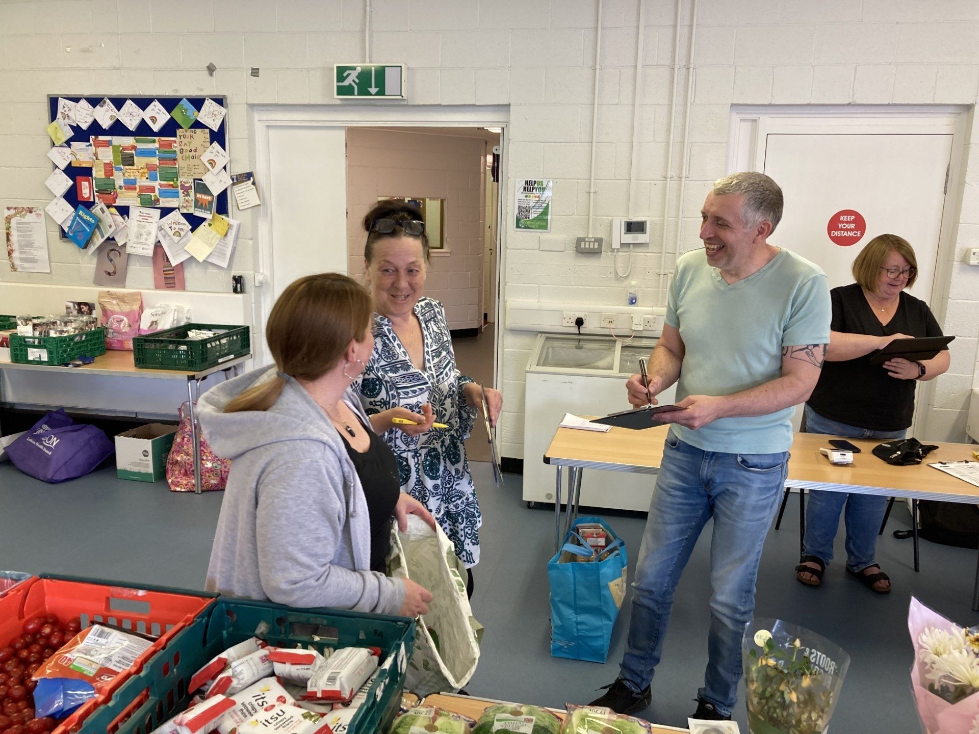 Councillor Andrew Miller works with other volunteers and customers at the Vennie food outlet in the Mosswood community centre in Knightsridge. 