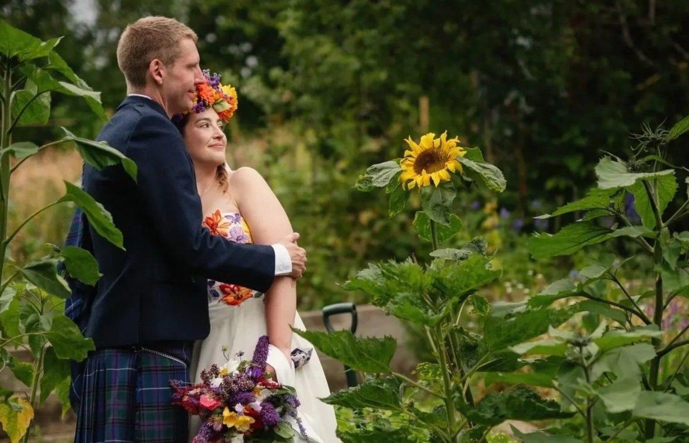 Newlyweds, Laura and Craig, pictured amid sunflowers on the allotments after their ceremony. Pic credit: Weddings by Bart. 