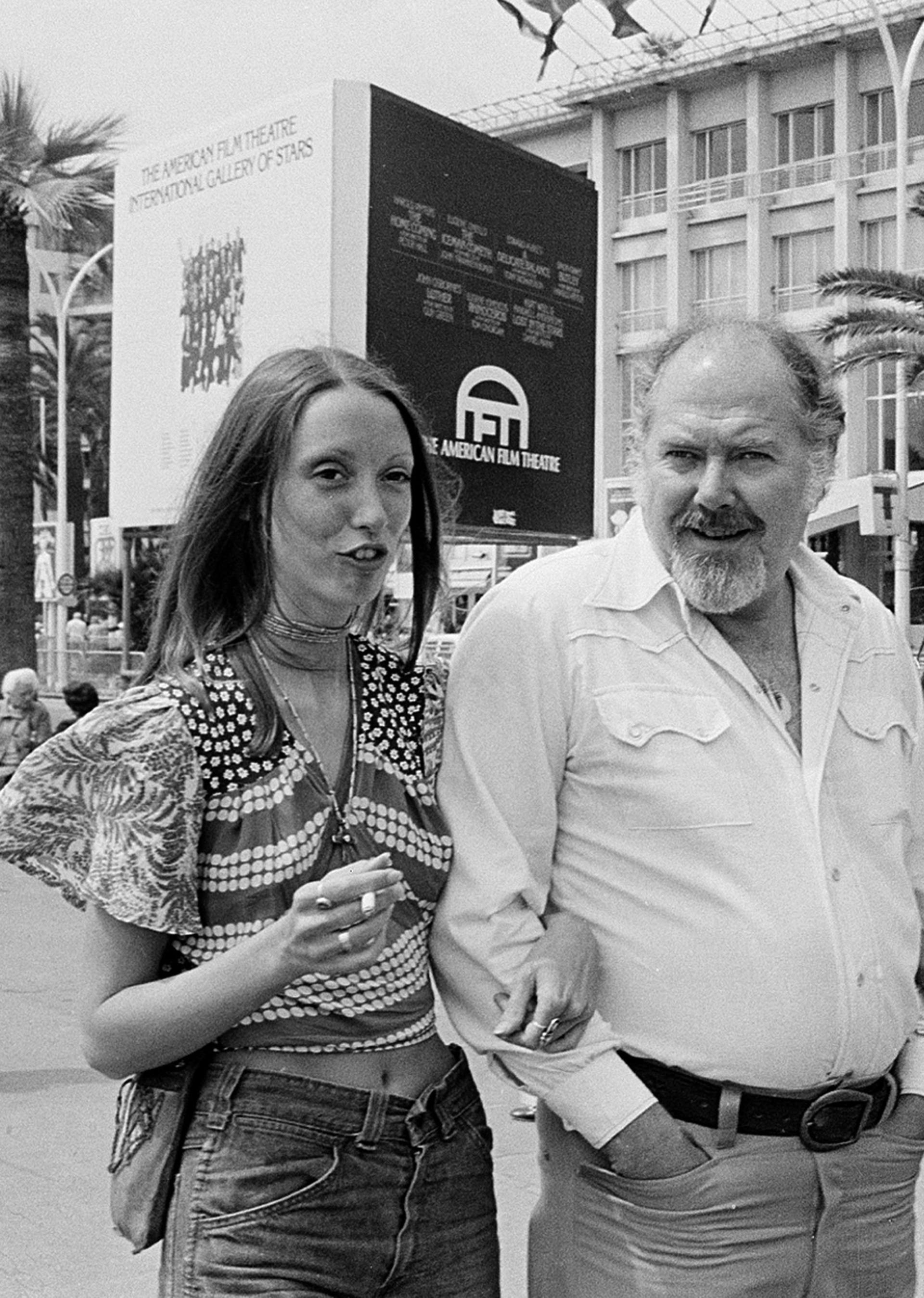 FILE - Shelley Duvall, left, and Robert Altman stroll along the Boulevard de la Croisette in Cannes, France, in May 1974. Duvall, whose wide-eyed, winsome presence was a mainstay in the films of Robert Altman and who co-starred in Stanley Kubrick's “The Shining,” has died. She was 75.  (AP Photo/Levy, File)