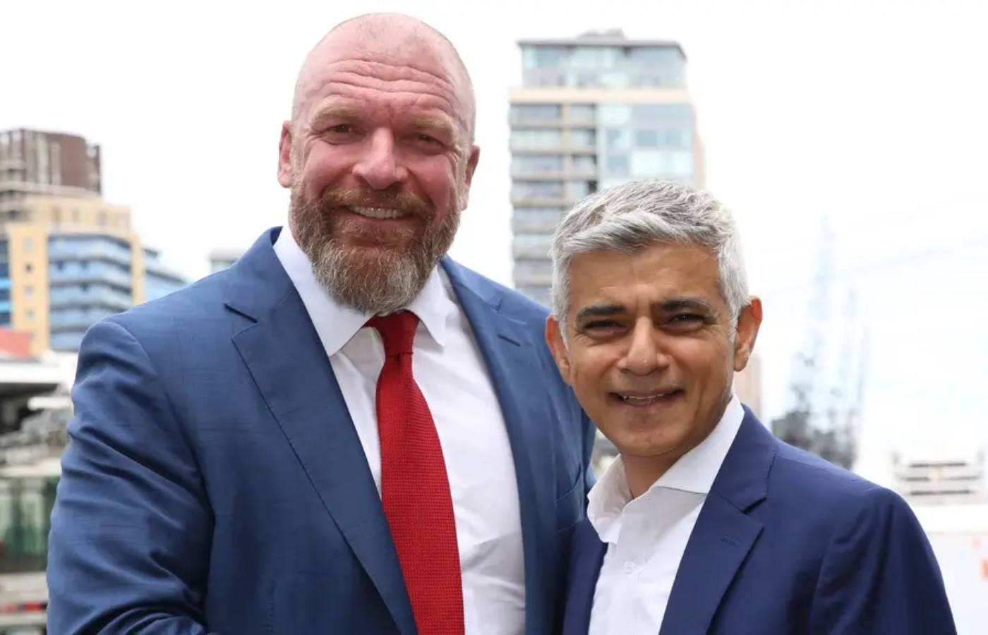 Paul Levesque and Sadiq Khan shake hands on the terrace at City Hall in London.