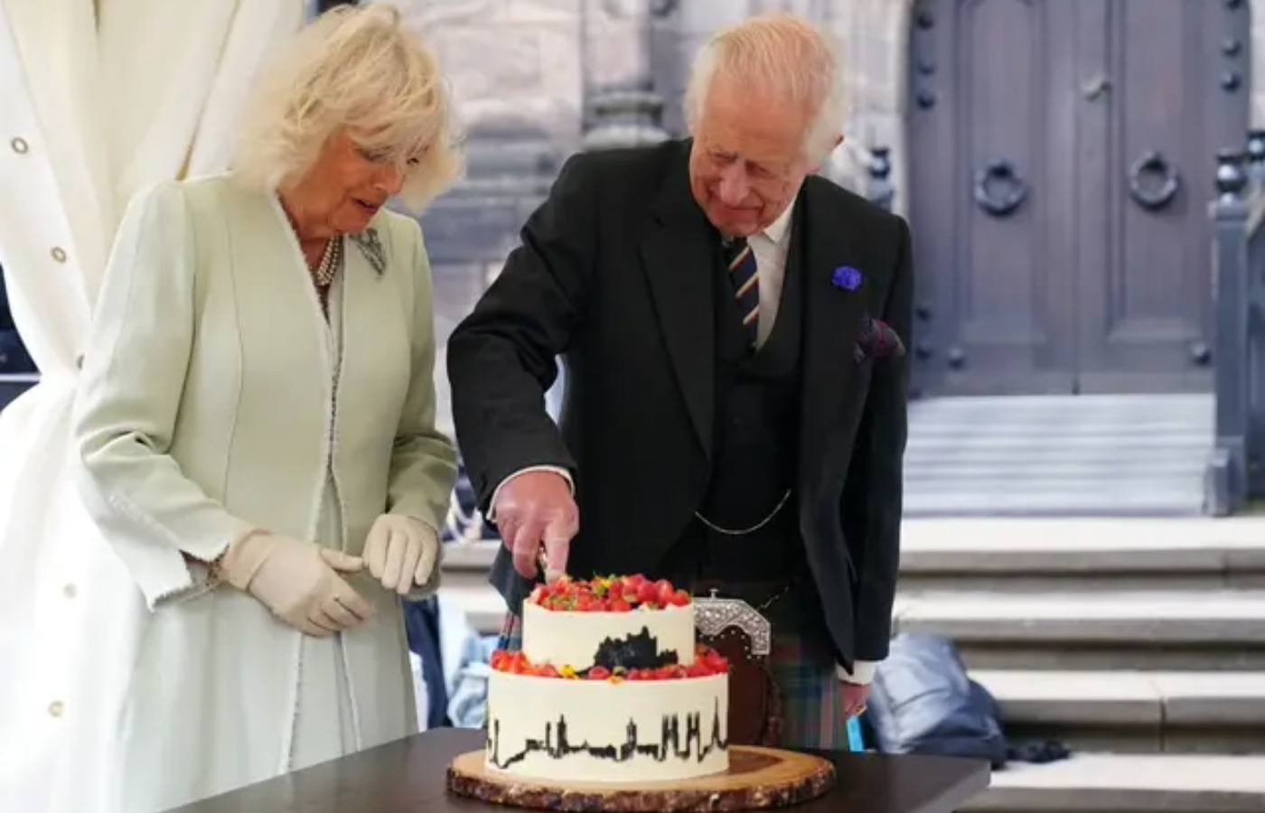 The King and Queen cut a cake made by 2020 Great British Bake Off winner Peter Sawkins.
