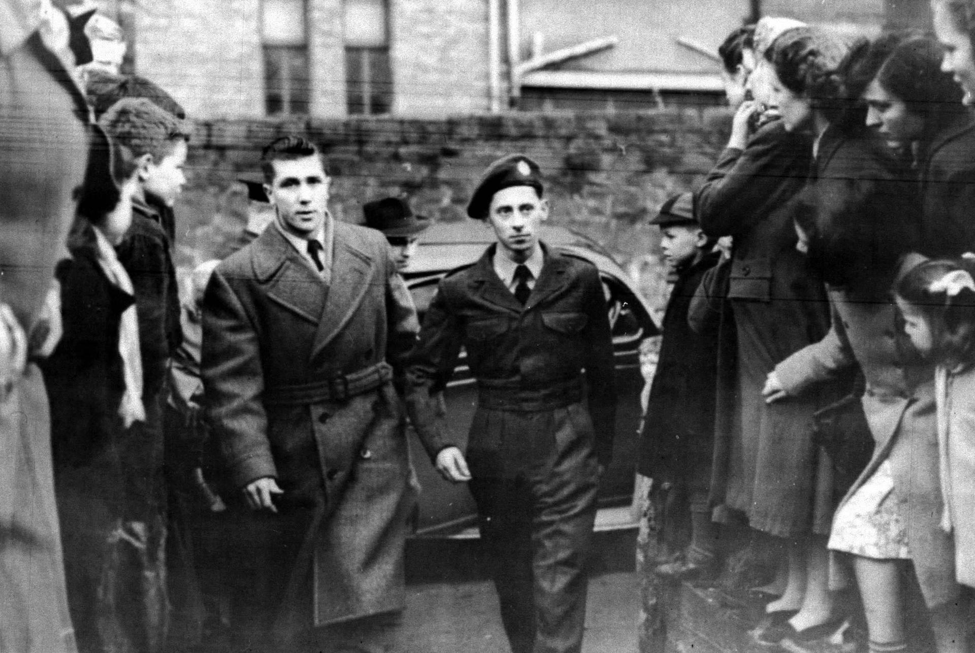 Iain Hay Gordon in uniform, being led to a court in Belfast, where he was found guilty of murdering judge’s daughter Patricia Curran in Co Antrim in November 1952.