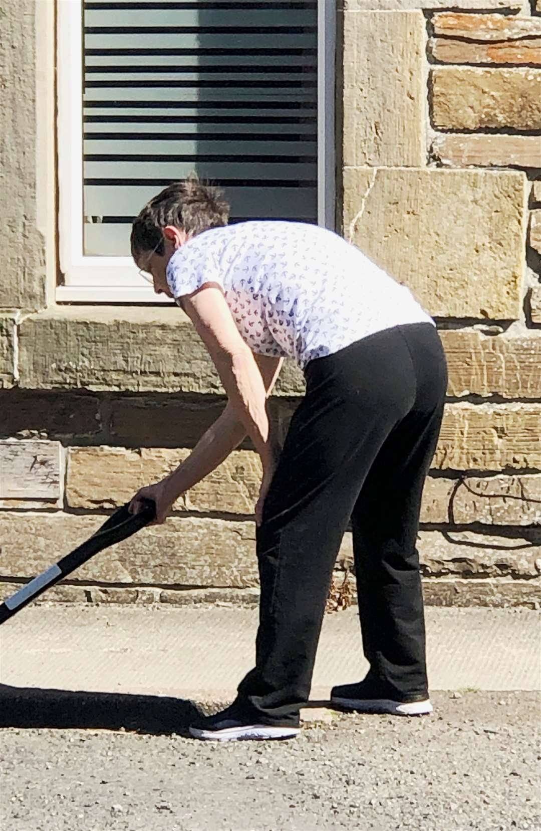 The 75-year-old was fed-up with potholes outside her house decided to fix them herself.