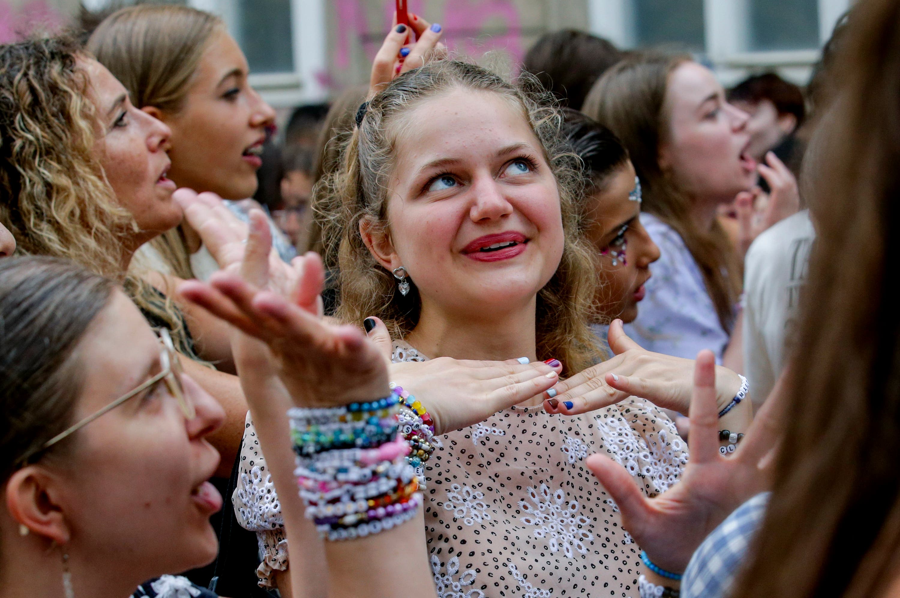 Swifties gather and sing in the city centre in Vienna on Thursday after the cancellation (Heinz-Peter Bader/AP/PA) 