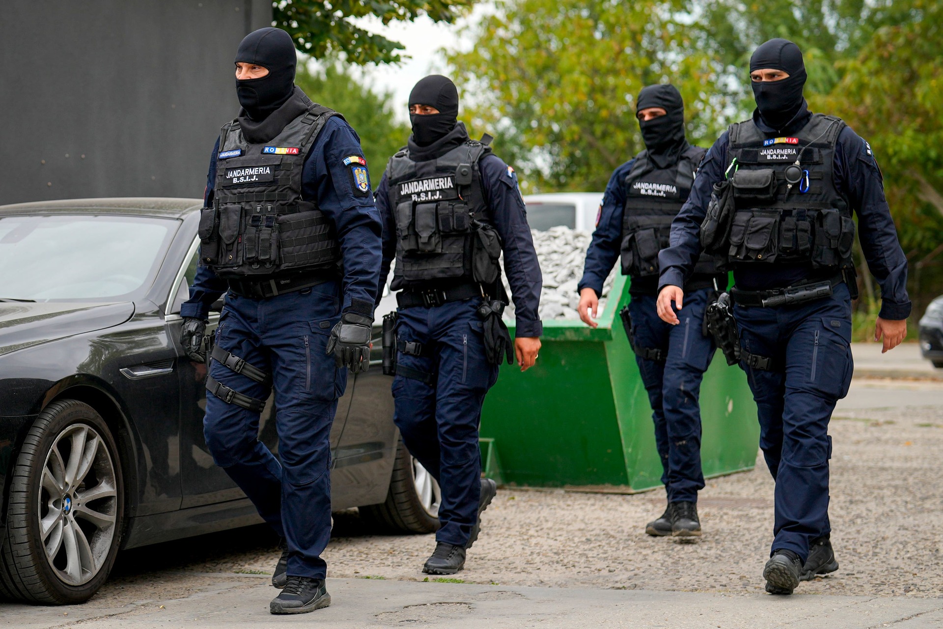 A police officer stands outside the residence of internet influencer Andrew Tate during an early morning police search raid on the outskirts of Bucharest, Romania