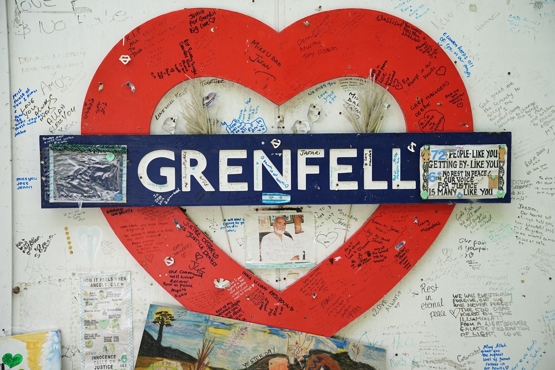 Undated file photo of a sign on the hoarding around Grenfell Tower – the Scottish Government introduced regulations around fire alarms in 2022 as a result of the fatal blaze (Aaron Chown/PA Wire). 