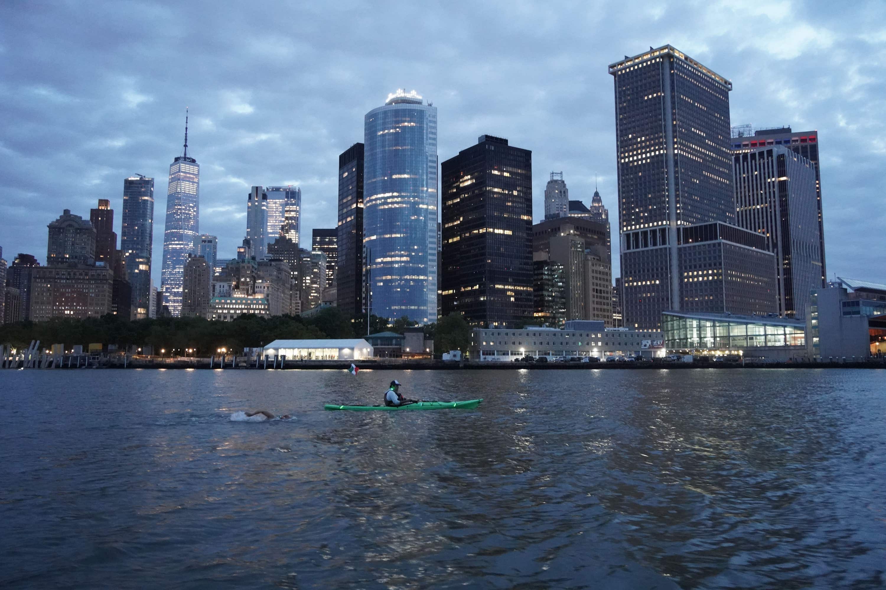 Crew members supported Andy Donaldson while he swam round Manhattan.