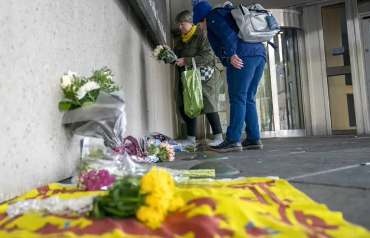 Members of the public place flowers outside the Scottish Parliament in Edinburgh after Alex Salmond’s death.