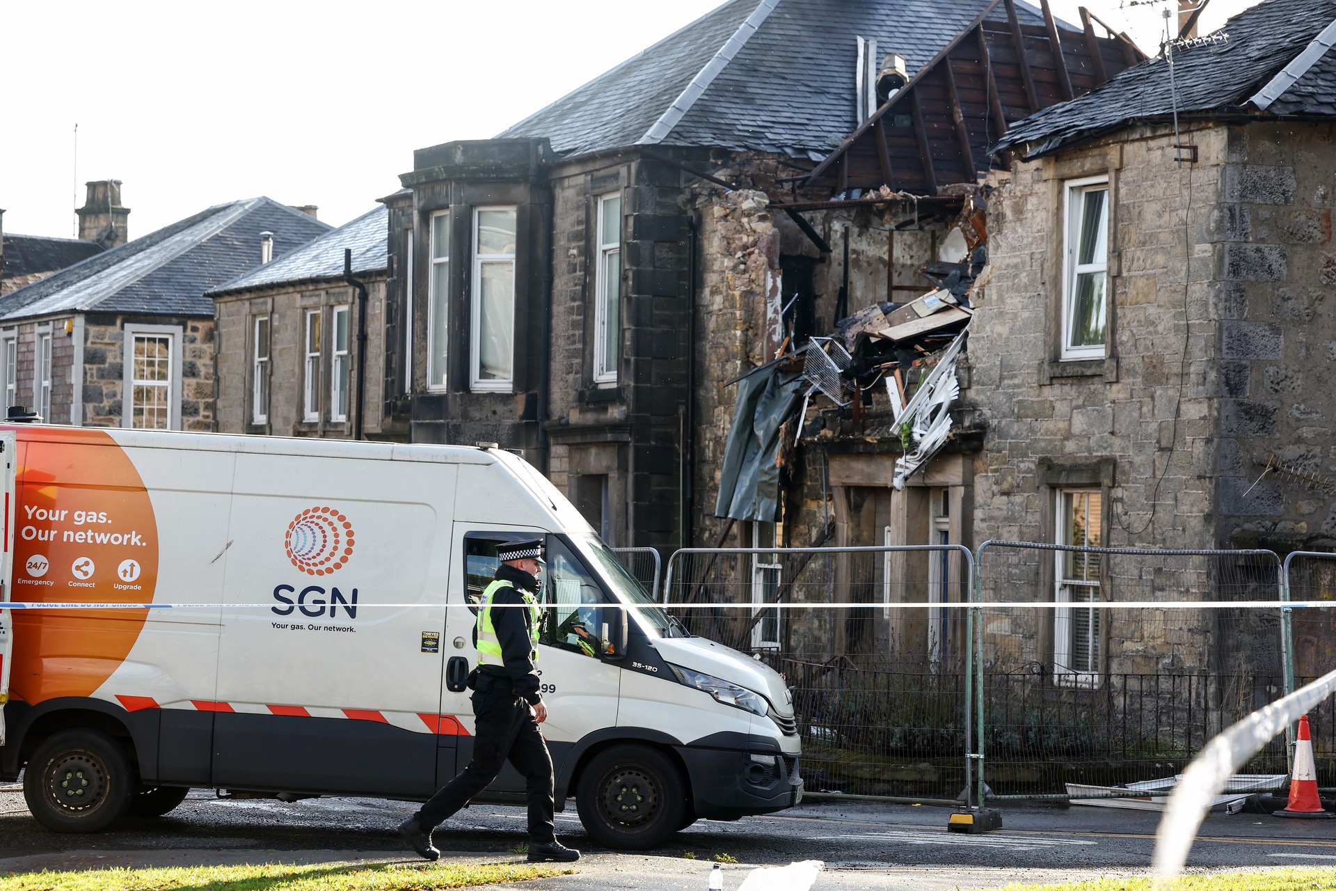 Gas workers attend the scene following an explosion in a block of flats in Alloa.