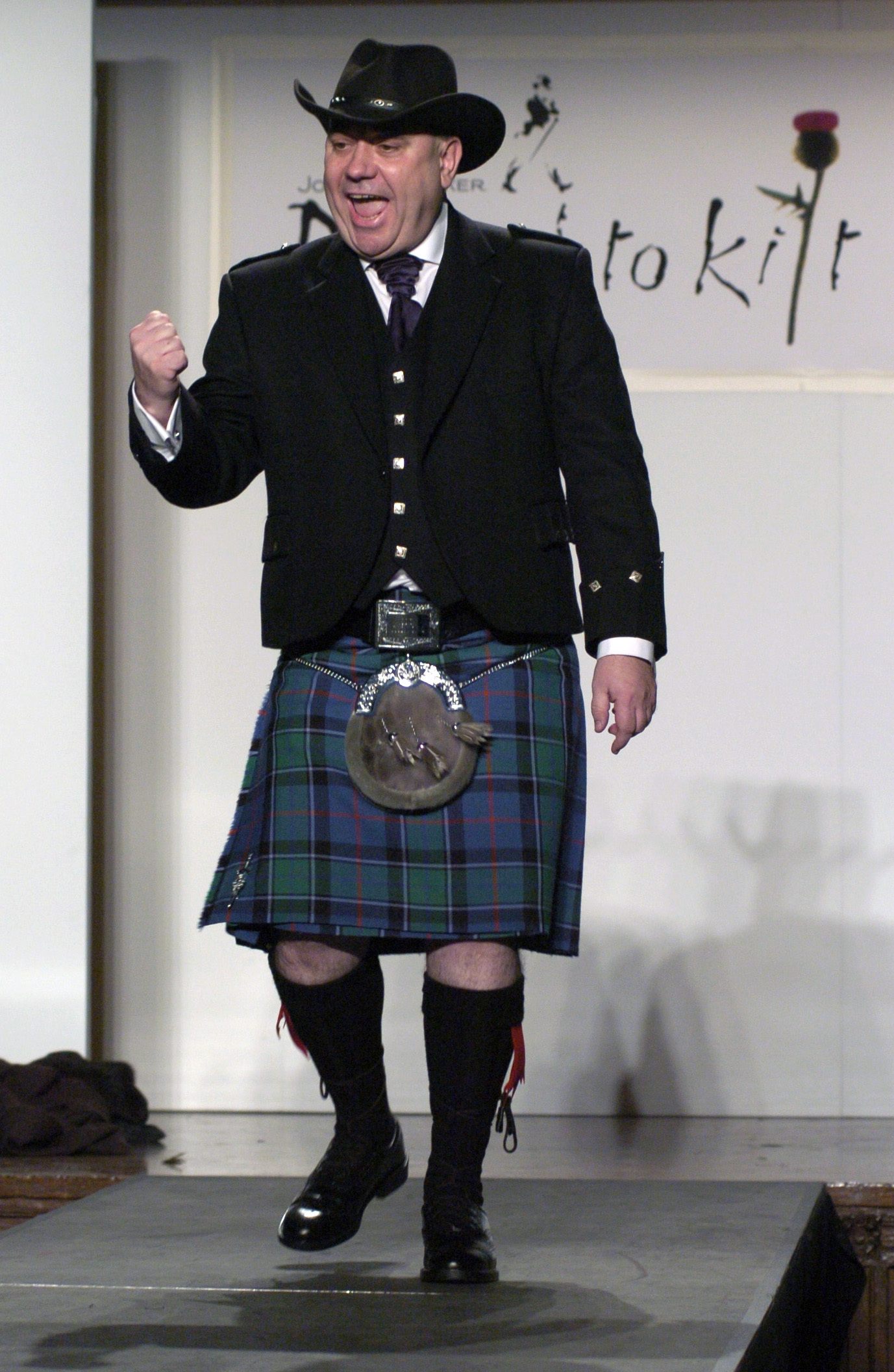 UNITED STATES - APRIL 03:  Scottish National Party Leader Alex Salmond walks down the runway at the 'Dressed to Kilt' fashion show held at the Synod House at St. John the Divine Cathedral Garden in New York on Monday, April 3, 2006. This annual fashion show and event benefits Friends of Scotland and is part of the annual Tartan Week.  (Photo by Rebecca Mcalpin/Bloomberg via Getty Images)