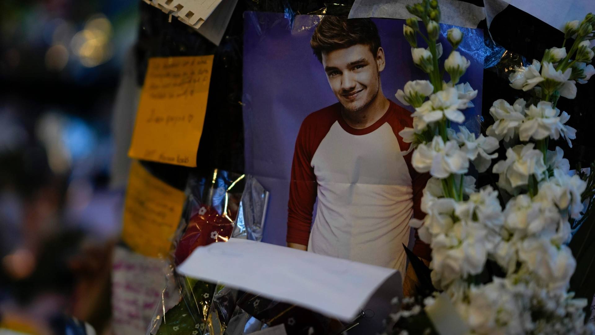 A picture of former One Direction singer Liam Payne adorns a memorial outside the hotel