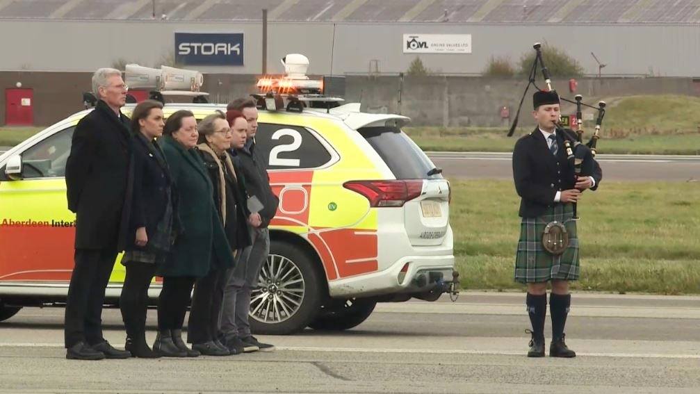 Members of Alex Salmond's family met the coffin at Aberdeen Airport