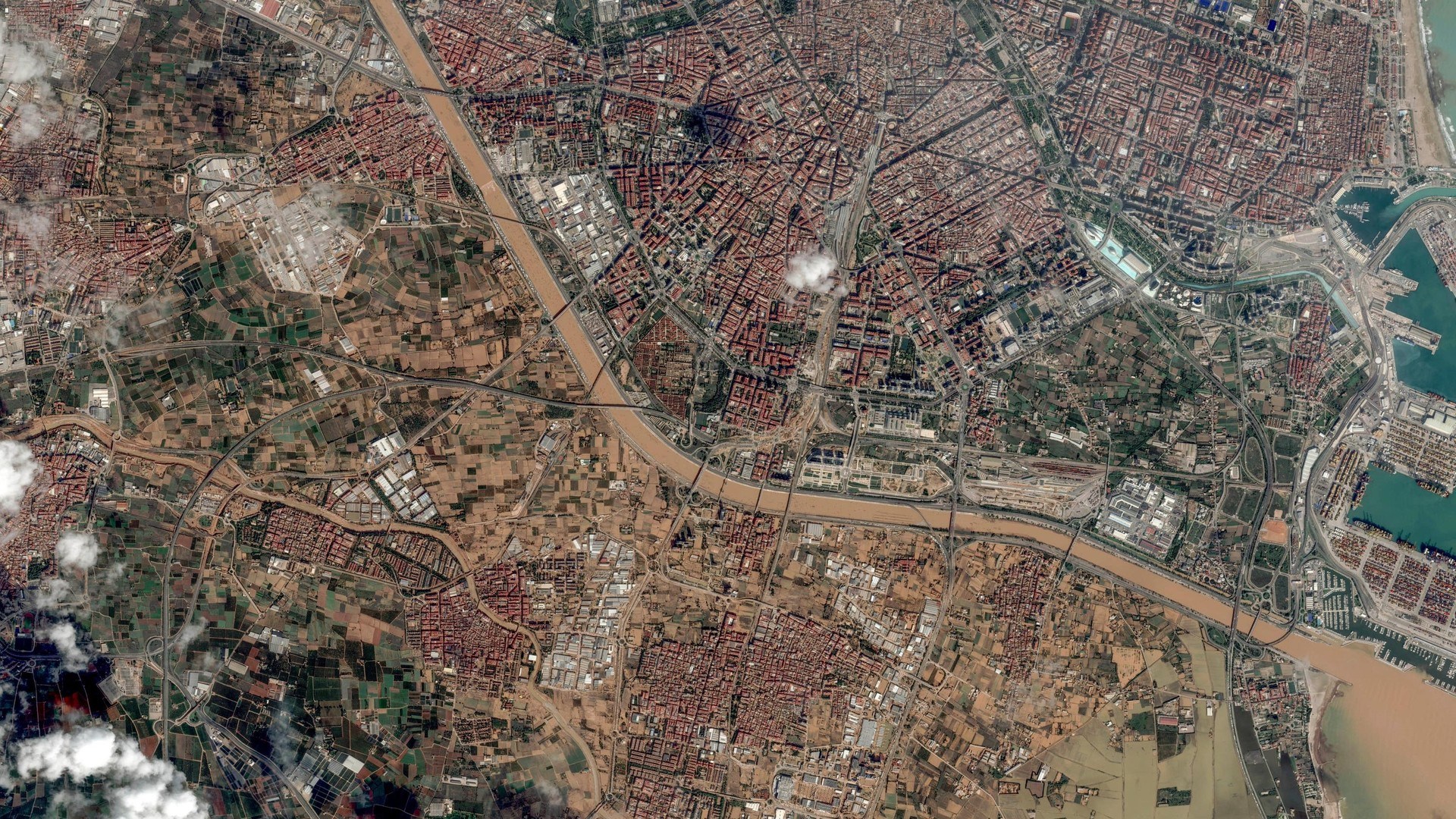 This satellite image released by Maxar Technologies shows mud caused by floods across Valencia, Spain