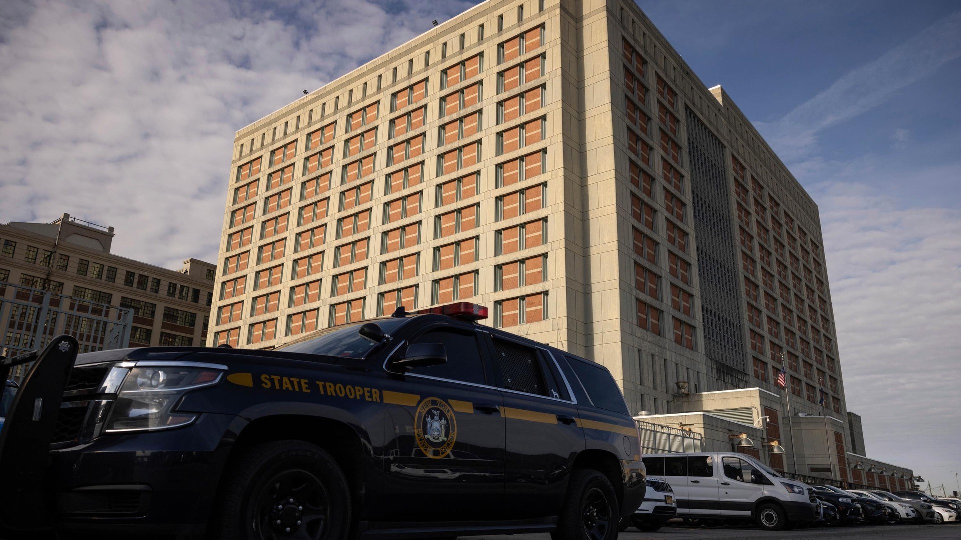 A state trooper vehicle is parked outside the Metropolitan Detention Centre