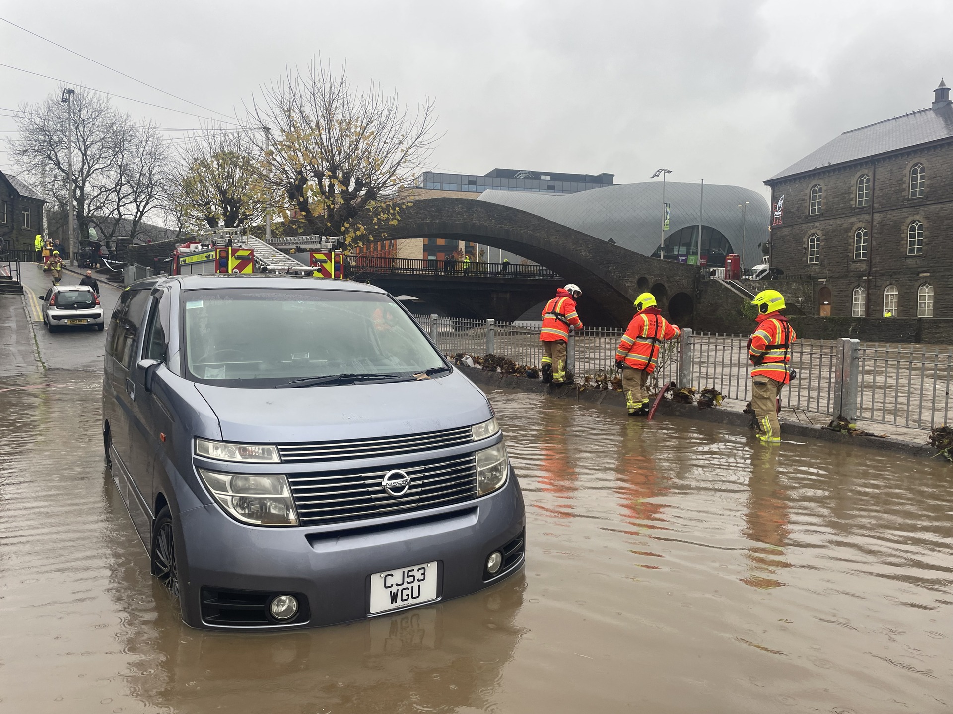 Firefighters pumping water from Sion Street by the River Taff, in Pontypridd (George Thompson/PA). 