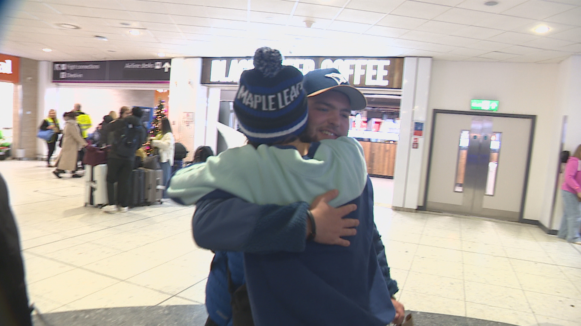 Angus and his sister Martha hug after a period studying abroad