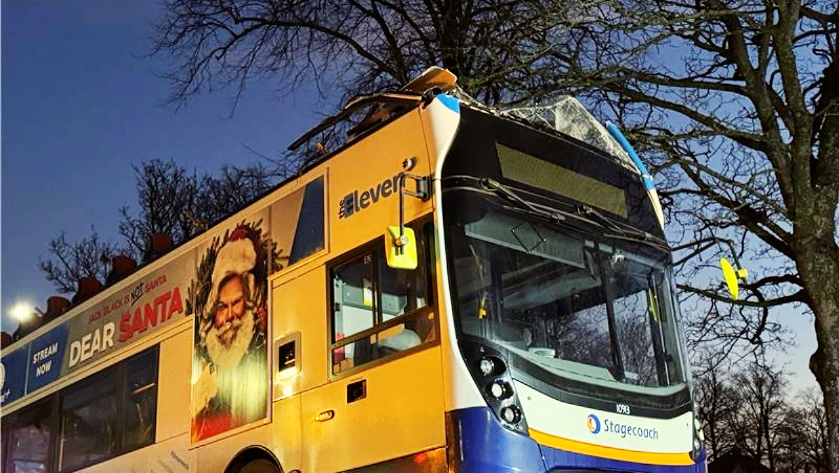 The double-decker bus had its roof torn off after crashing into a railway bridge in East Ayrshire.