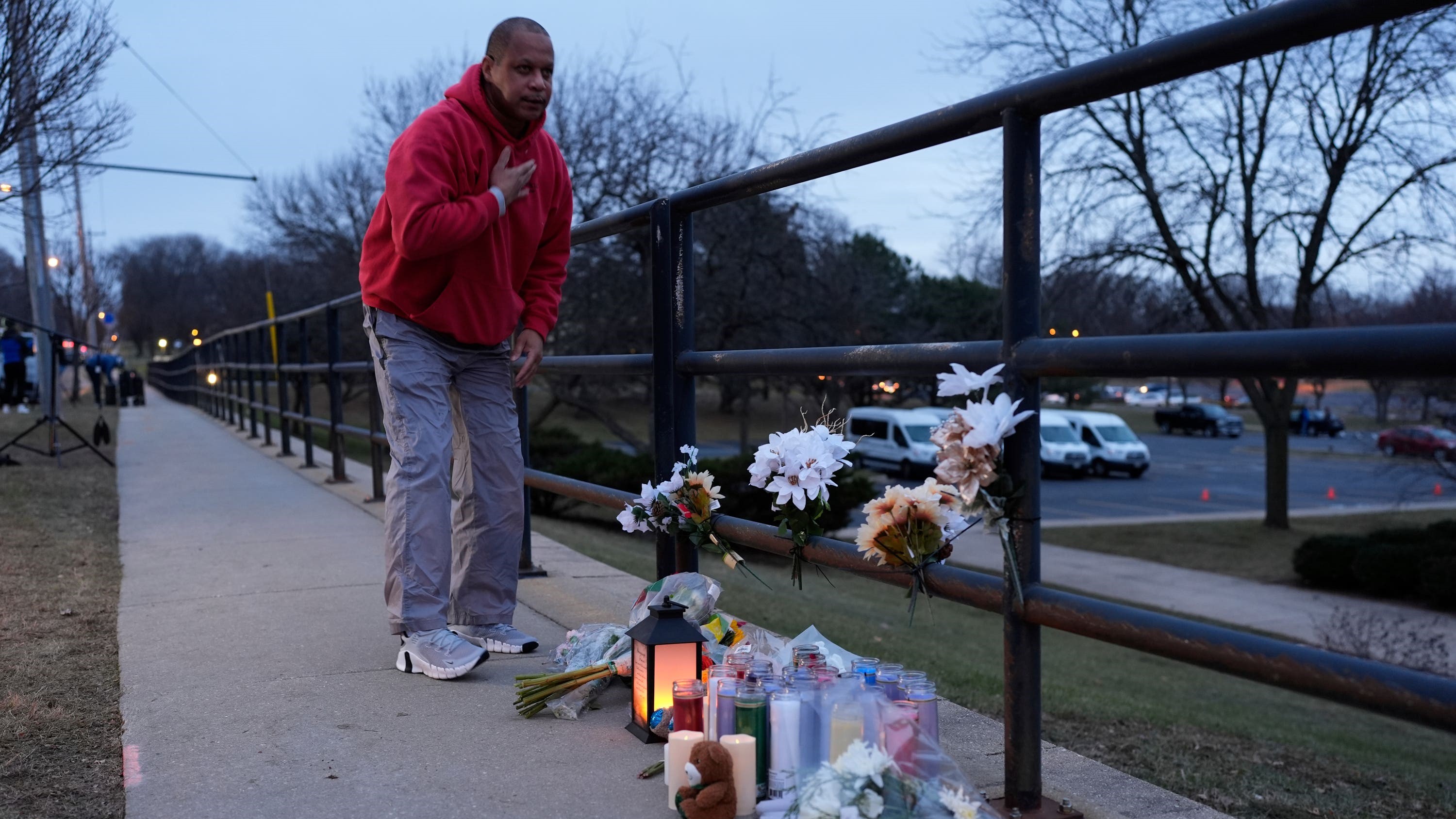 A person who did not wish to give his name places flowers outside the Abundant Life Christian School