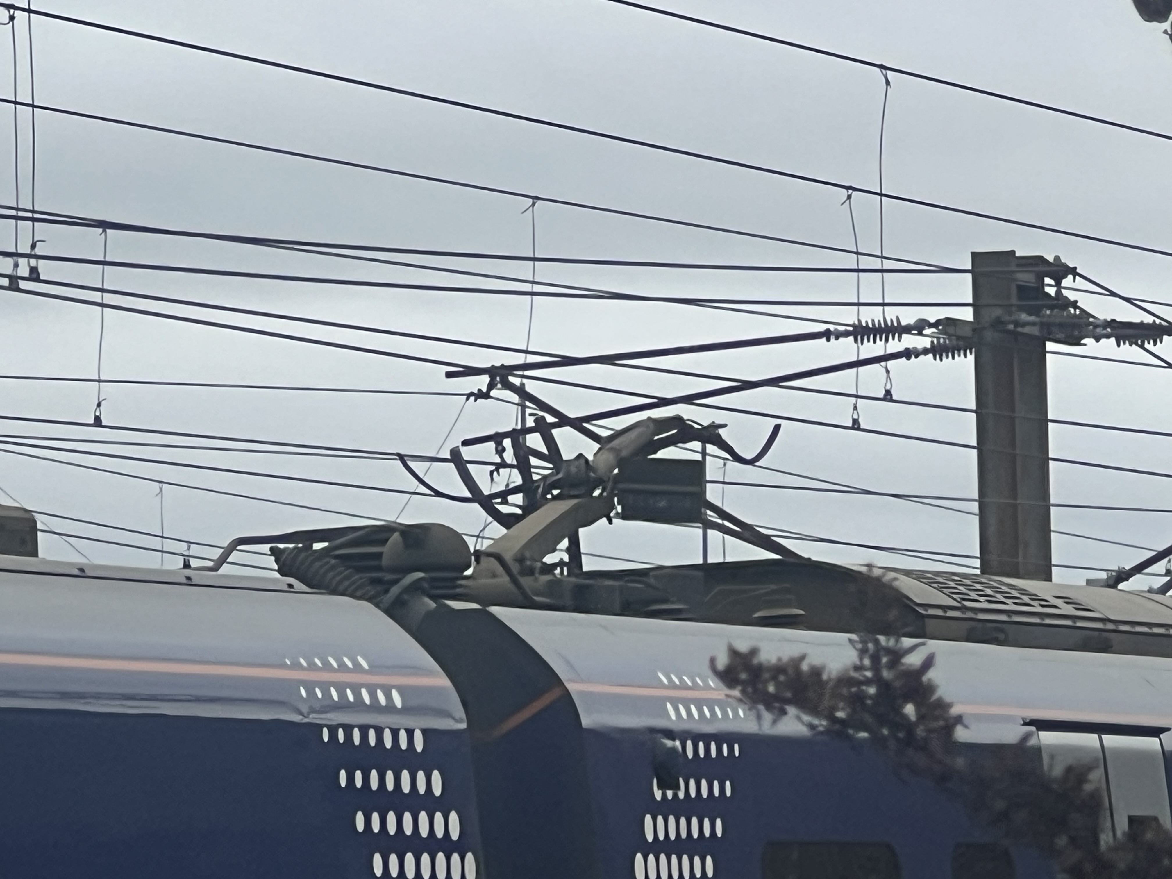 Photo of some of the damaged overhead line equipment near Newton station on the West Coast Main Line. There's significant damage to both the mast and the wires themselves which we need to repair.