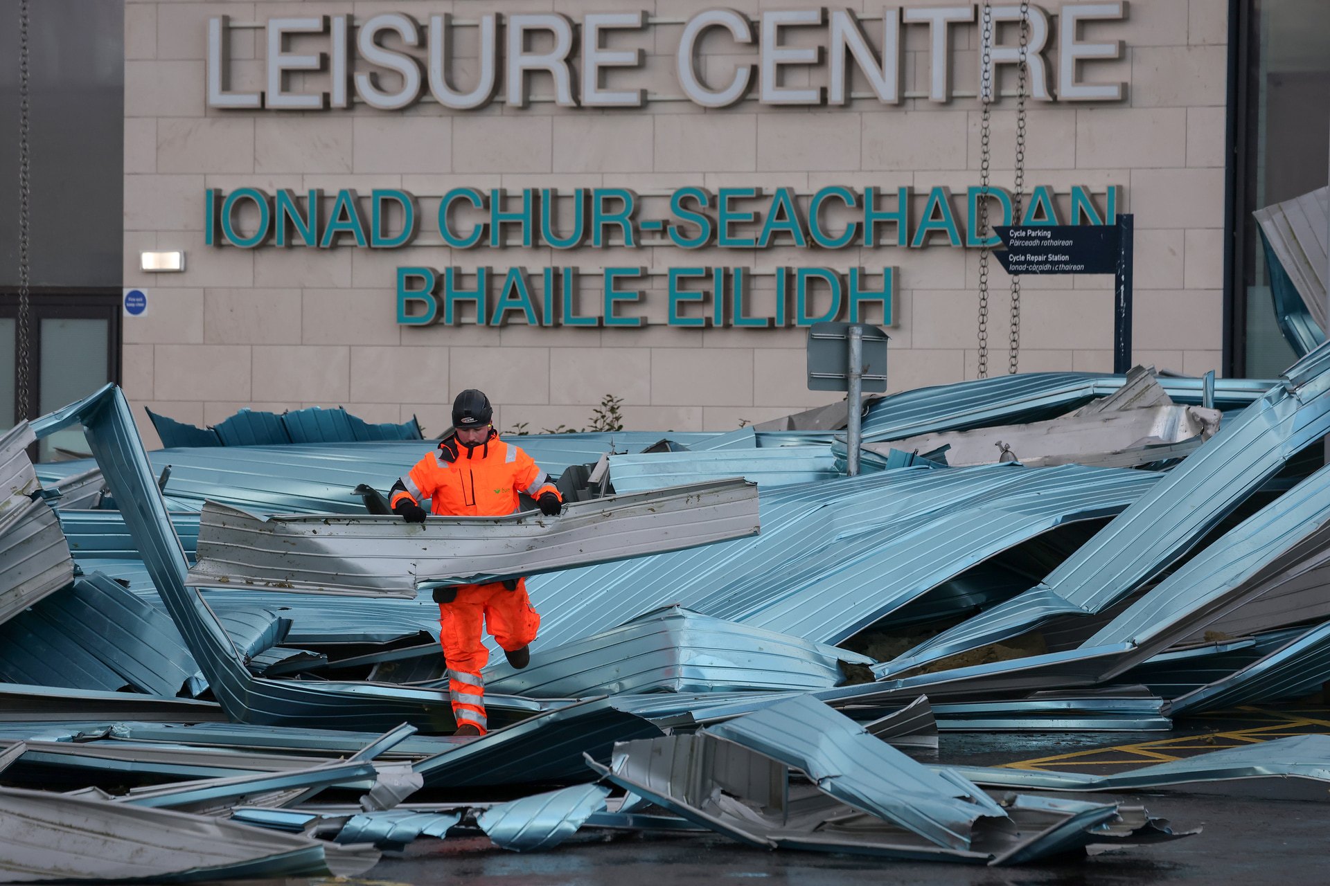  Workers clear debris from the roof blown off a leisure centre during storm Eowyn on January 25, 2025 in Helensburgh, Scotland. Scotland was issued with a rare red weather warning yesterday. Storm Éowyn left over 120,000 homes without power, two people in hospital and a trail of devastation across the country. (Photo by Jeff J Mitchell/Getty Images)