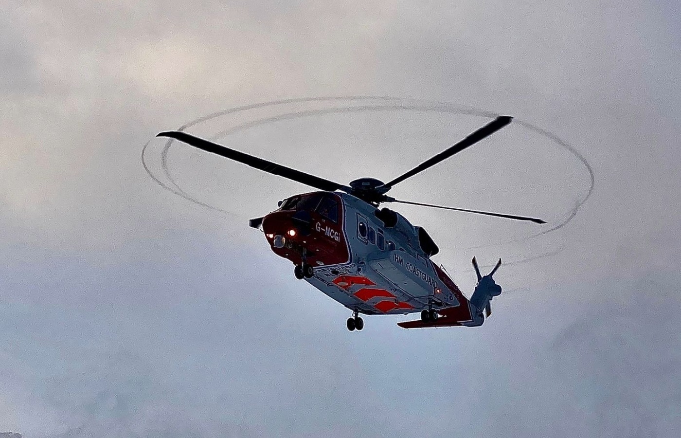 HM Coastguard's Rescue 948 picked up the hillwalker in between snow showers.