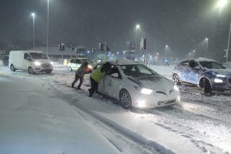 Heavy snow causes travel disruption across UK as amber warnings remain