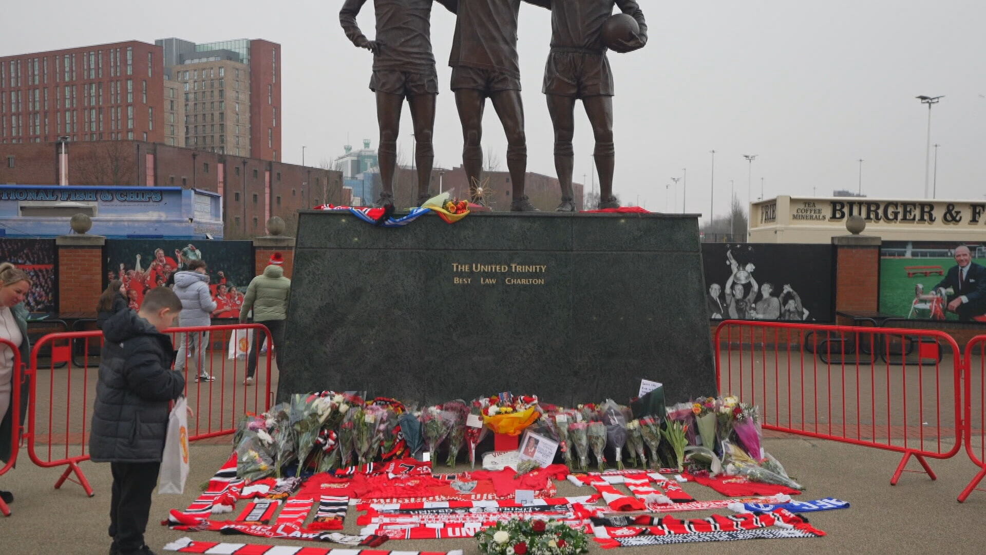 Flowers laid at Law's statue at Old Trafford in Manchester