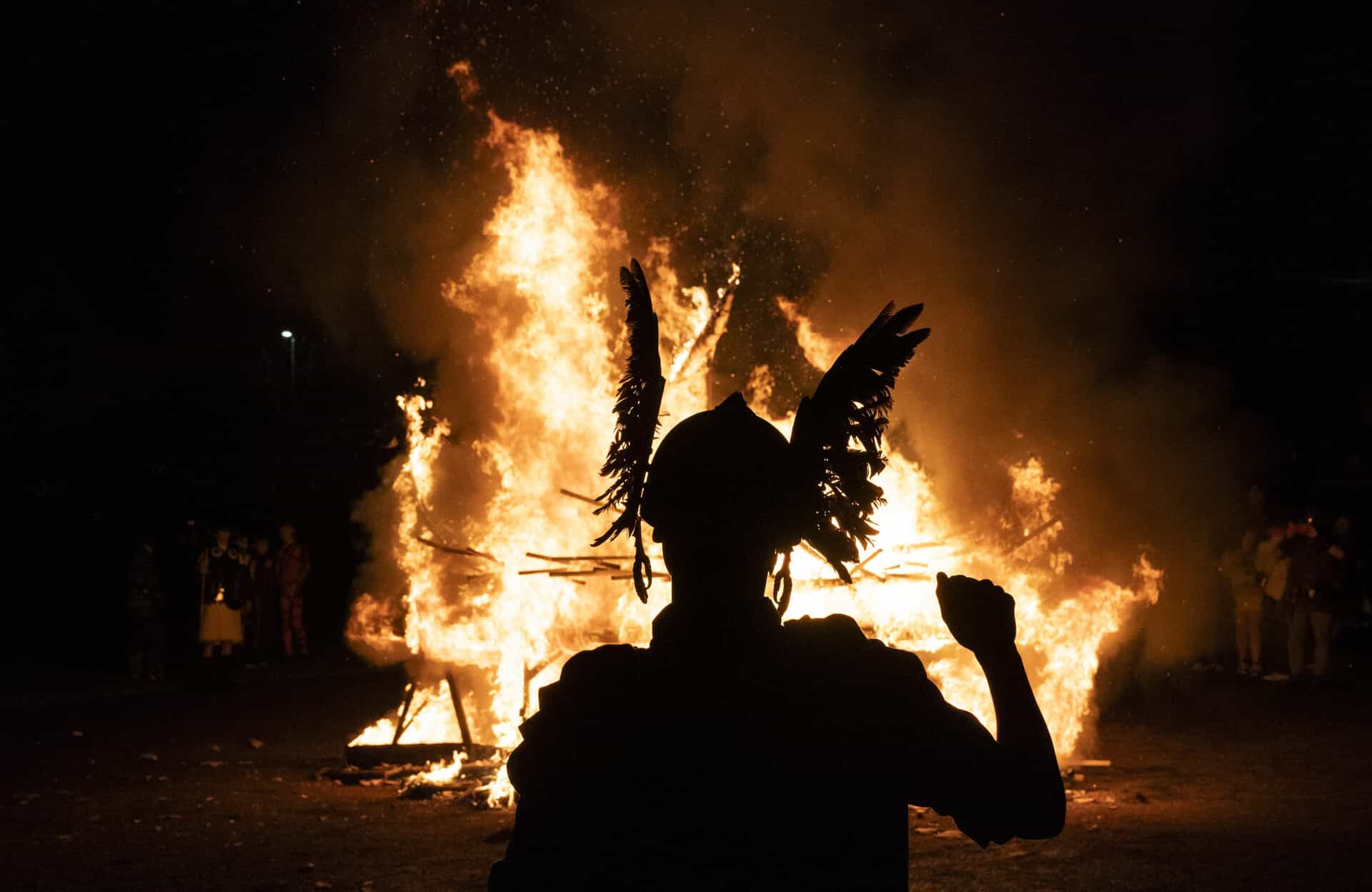 Fire takes hold as youngsters watch on (Jane Barlow/PA) 