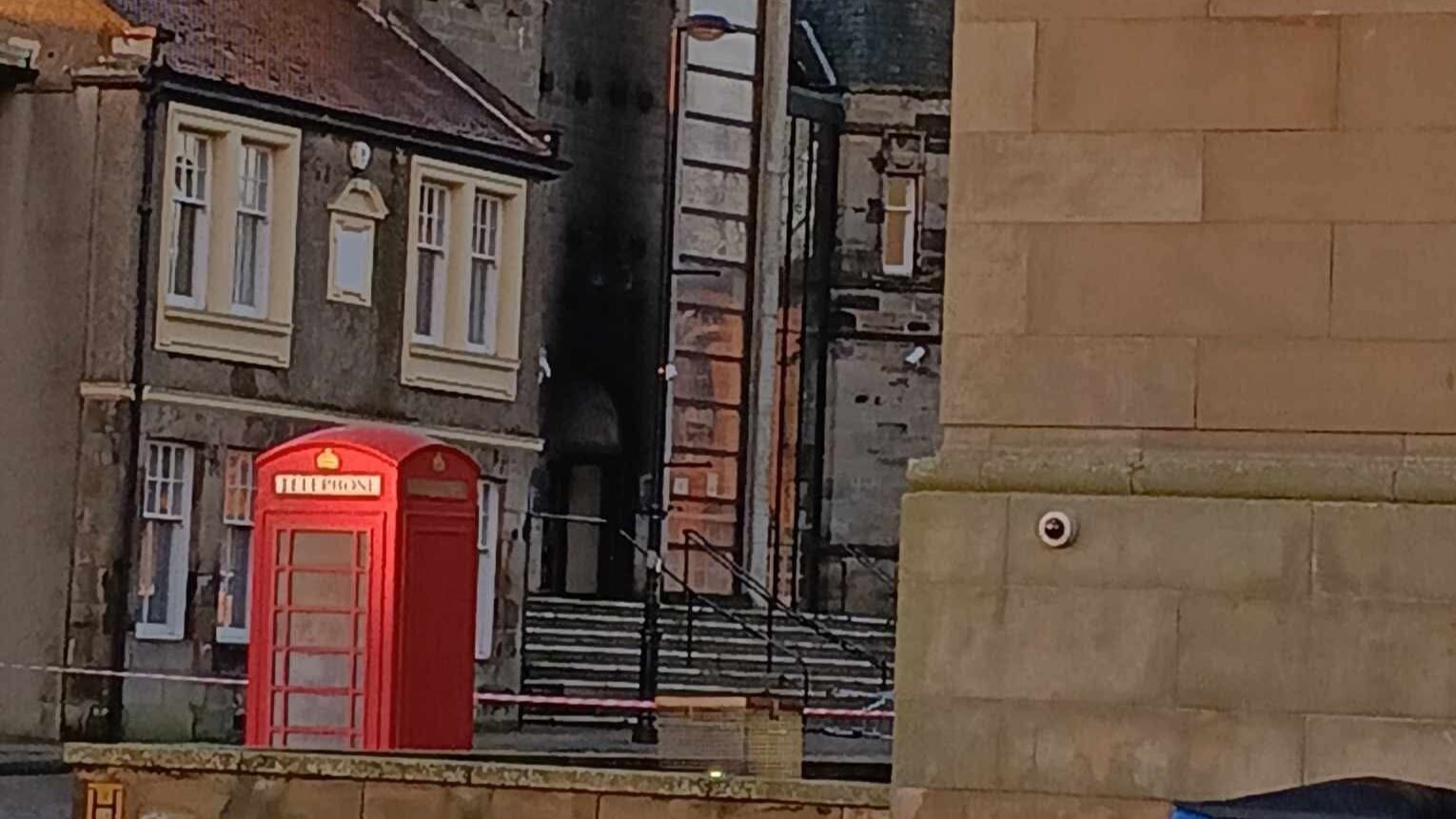 The door appears to be charred after it was set alight.