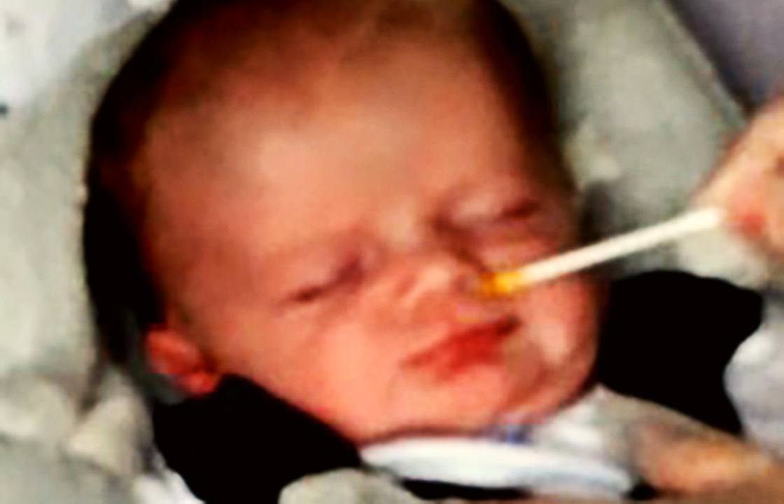 A baby making a laughter face in response to carrot odour. The three-week-old baby made a 