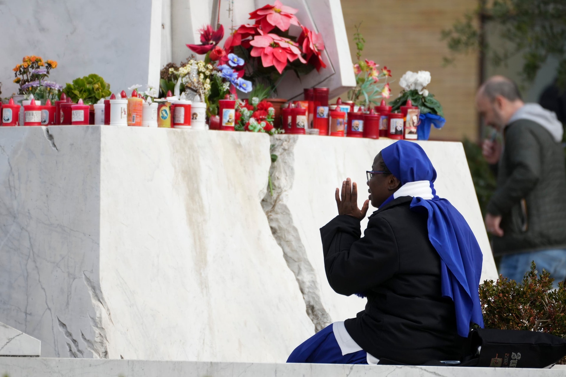 A nun sits in front of the main entrance of the Agostino Gemelli Polyclinic in Rome (Andrew Medichini/AP) 