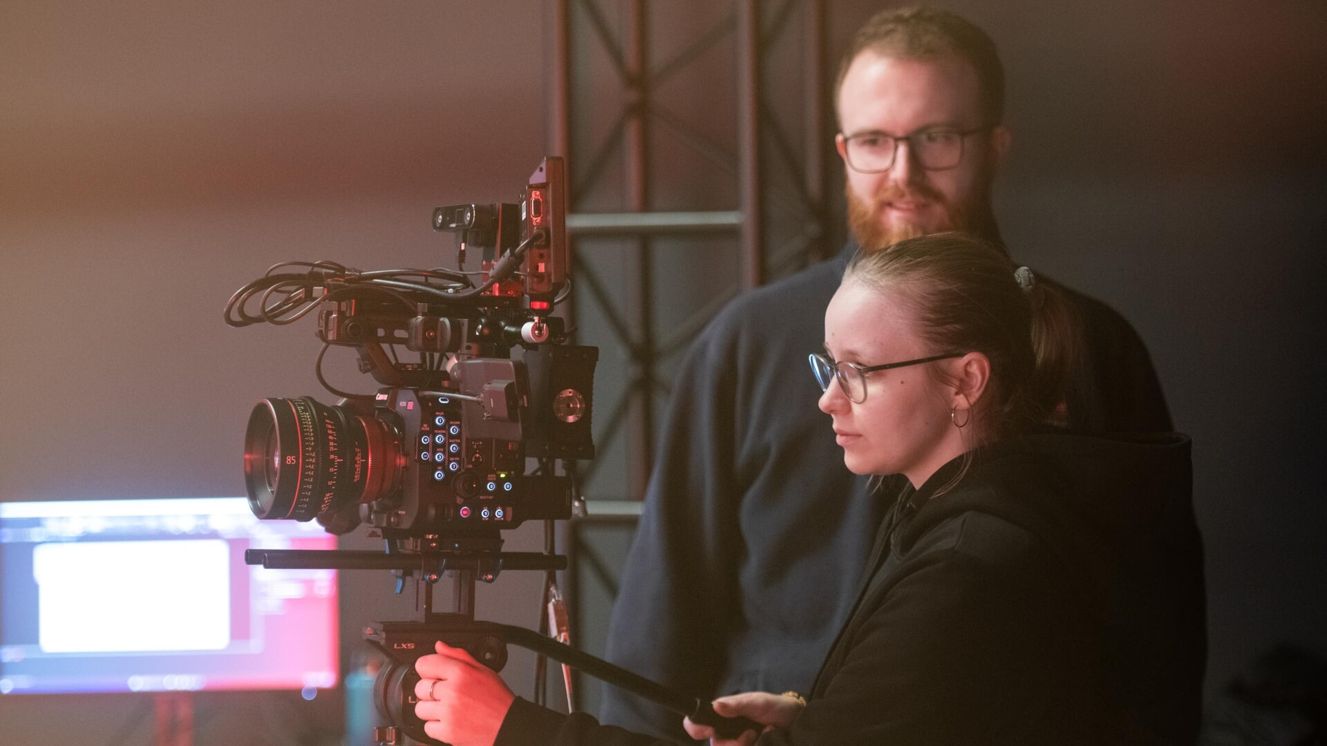 A videographer uses a cutting-edge camera atop a tripod in the new studio