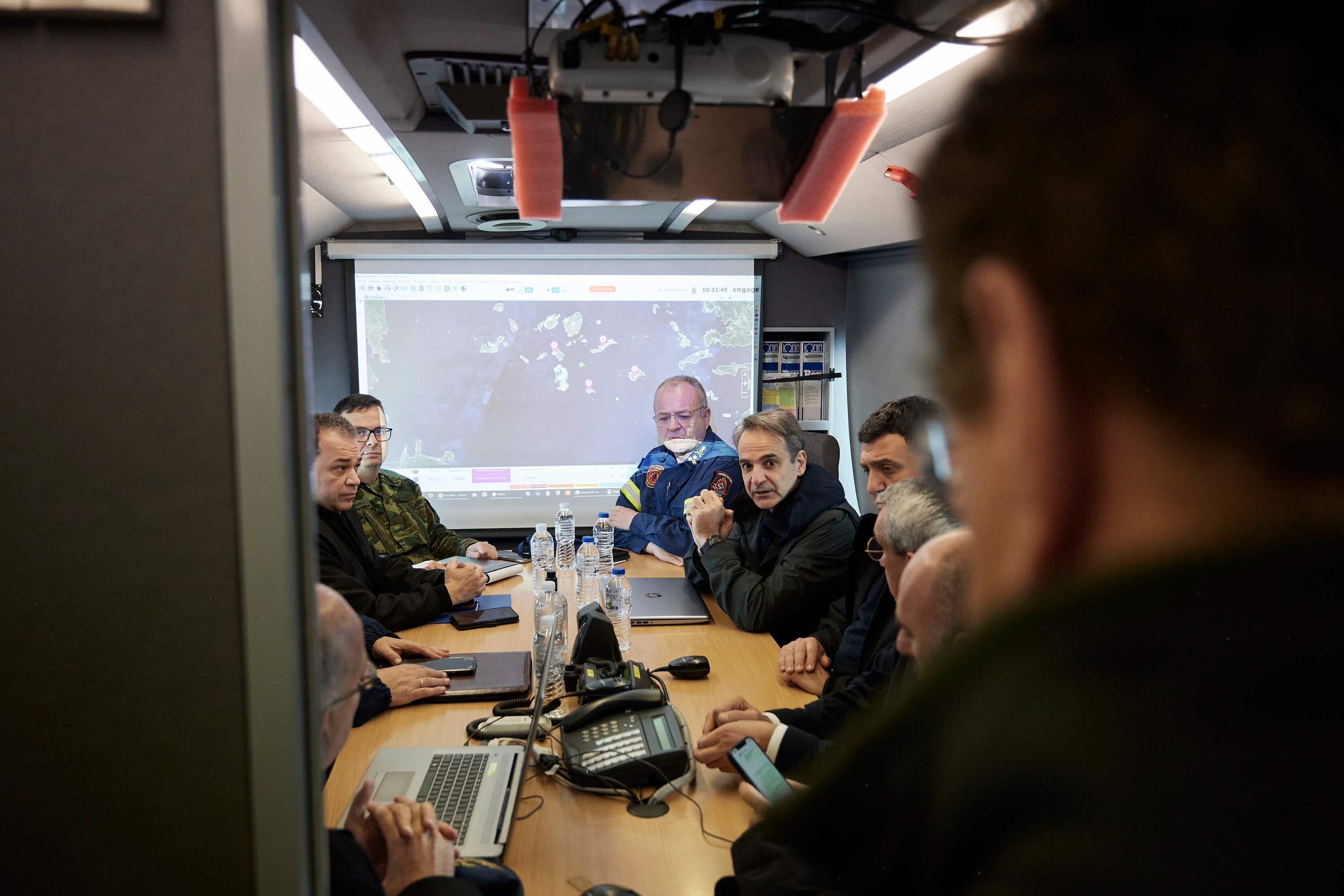 Kyriakos Mitsotakis, centre, gets an update during his visit to the temporary headquarters of emergency services on Santorini (Dimitris Papamitsos/Greek Prime Minister’s Office via AP) 