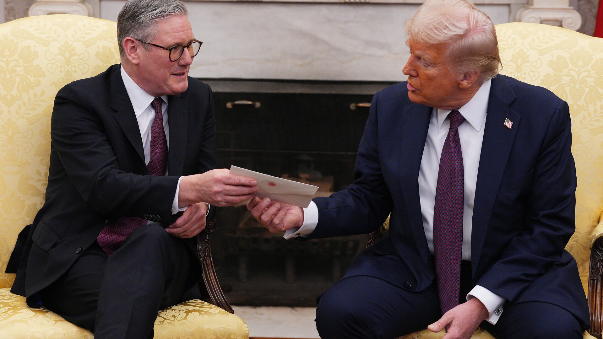 US President Donald Trump is presented with a letter from King Charles III, who invited him for an unprecedented second state visit, during his meeting with Prime Minister Sir Keir Starmer.