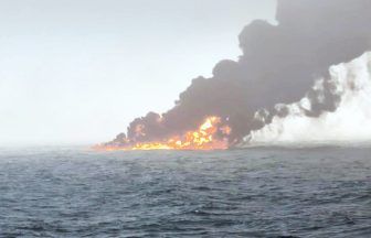 Crew member still missing as oil tanker and cargo ship crash continues to burn