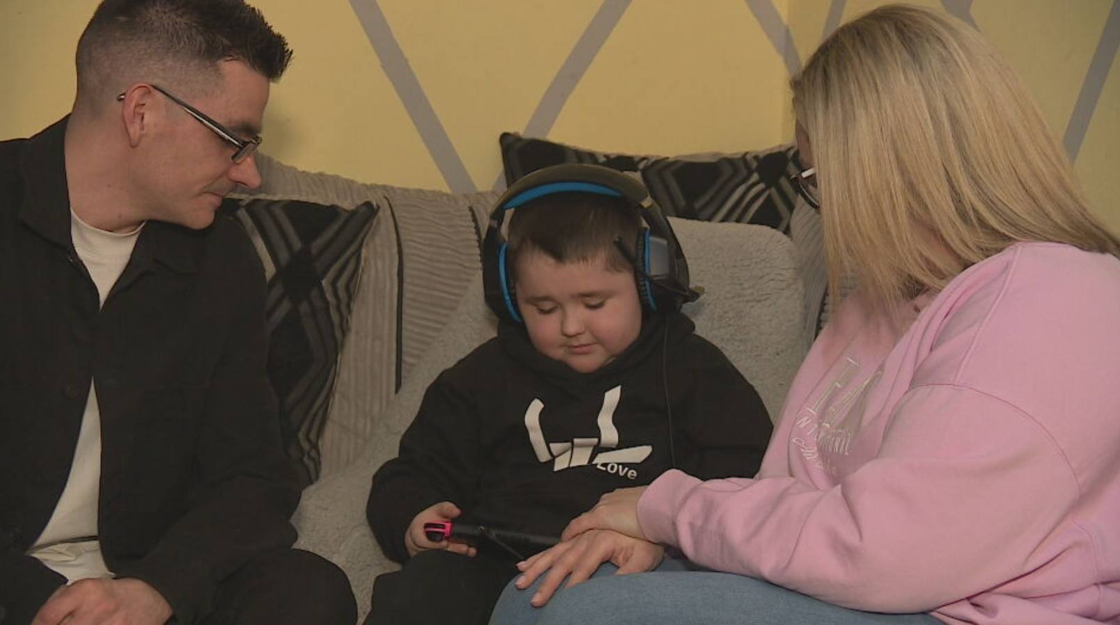 Sam, eight, with his parents Karla and Stephen