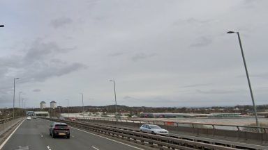 Part of M8 closed during rush hour after man found injured