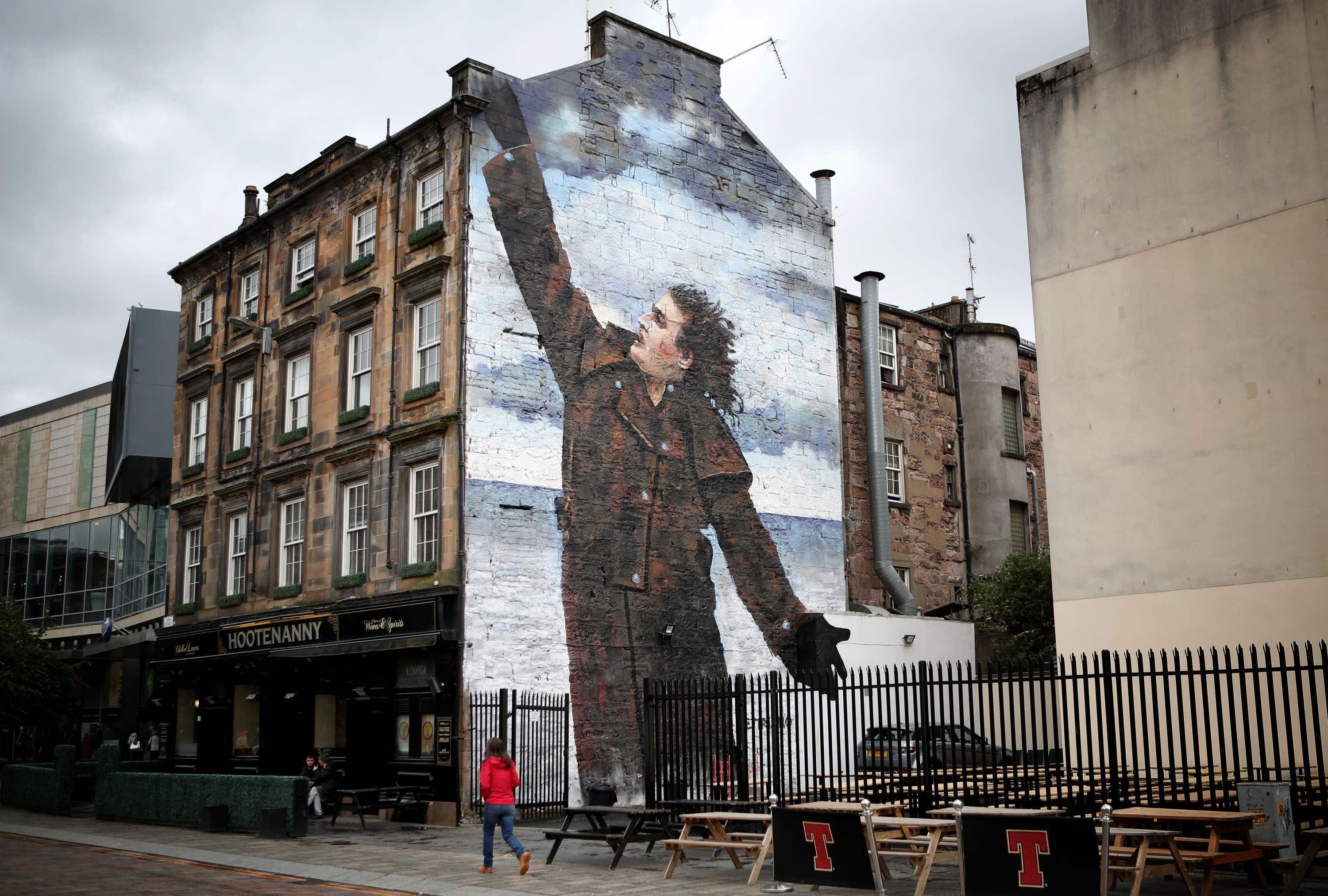 Vettriano’s portrait of Sir Billy Connolly was recreated as a mural (Jane Barlow/PA).