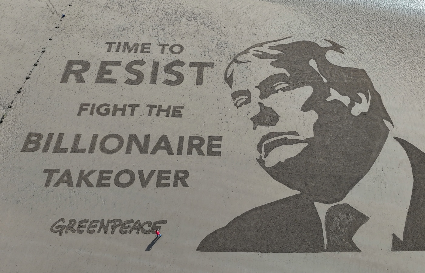 Greenpeace UK revealed a 55m by 40m artwork on the beach outside Trump’s golf course in Scotland.