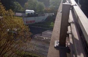 Road remains closed after lorry crashes off M90 motorway bridge