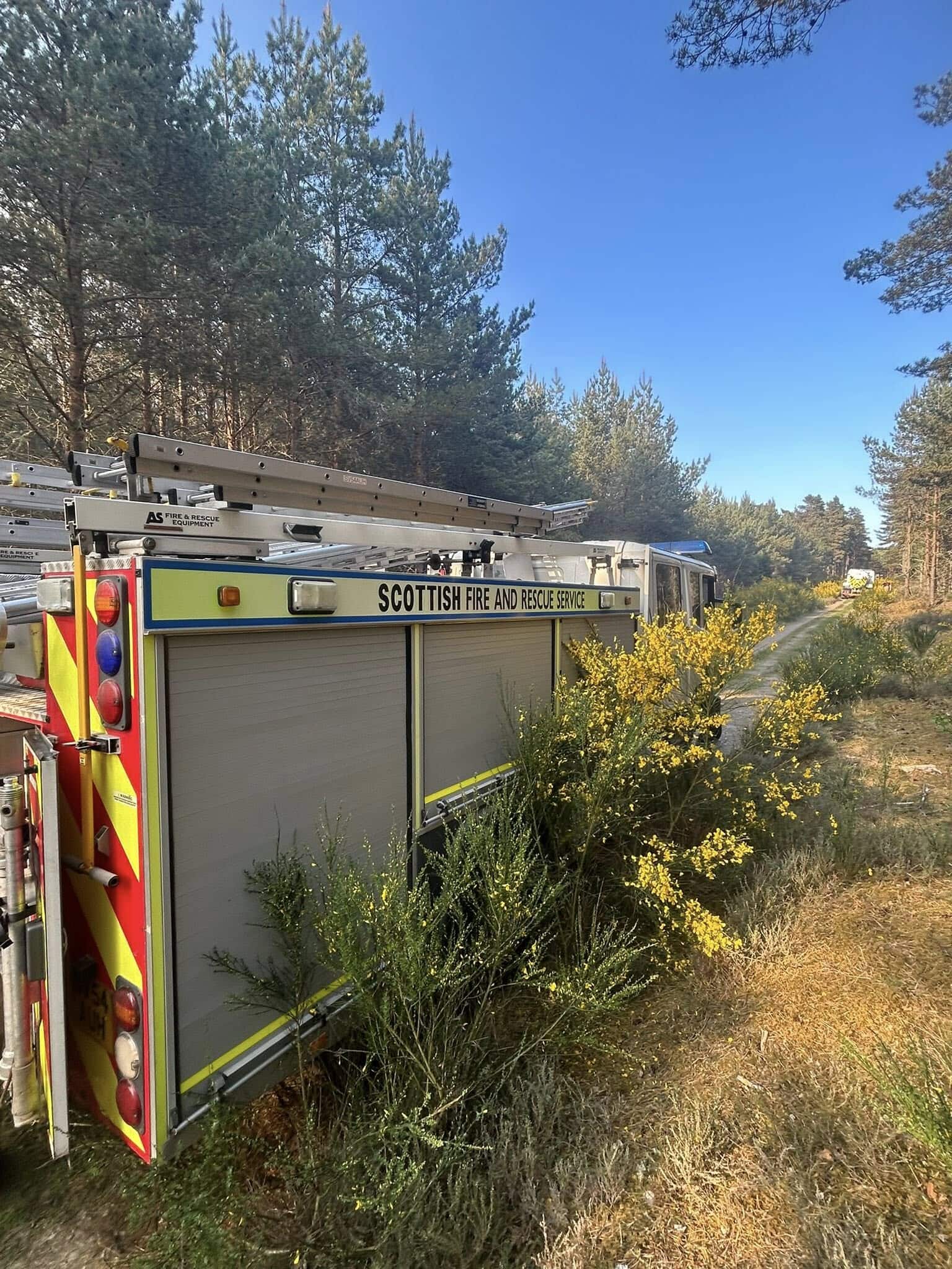 A helicopter is also at the scene dropping water on the affected area.