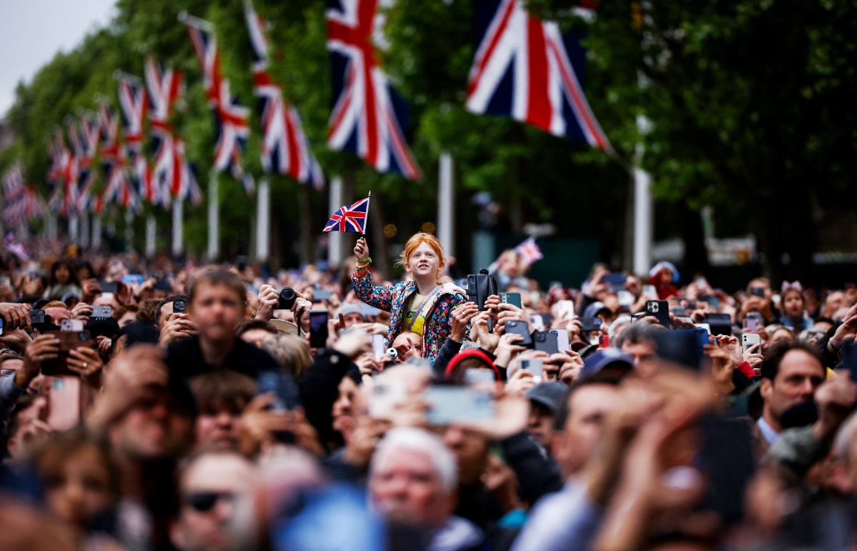 Members of the public walk down the mall in central London.