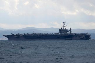 Fighter jet landing on US aircraft carrier goes overboard