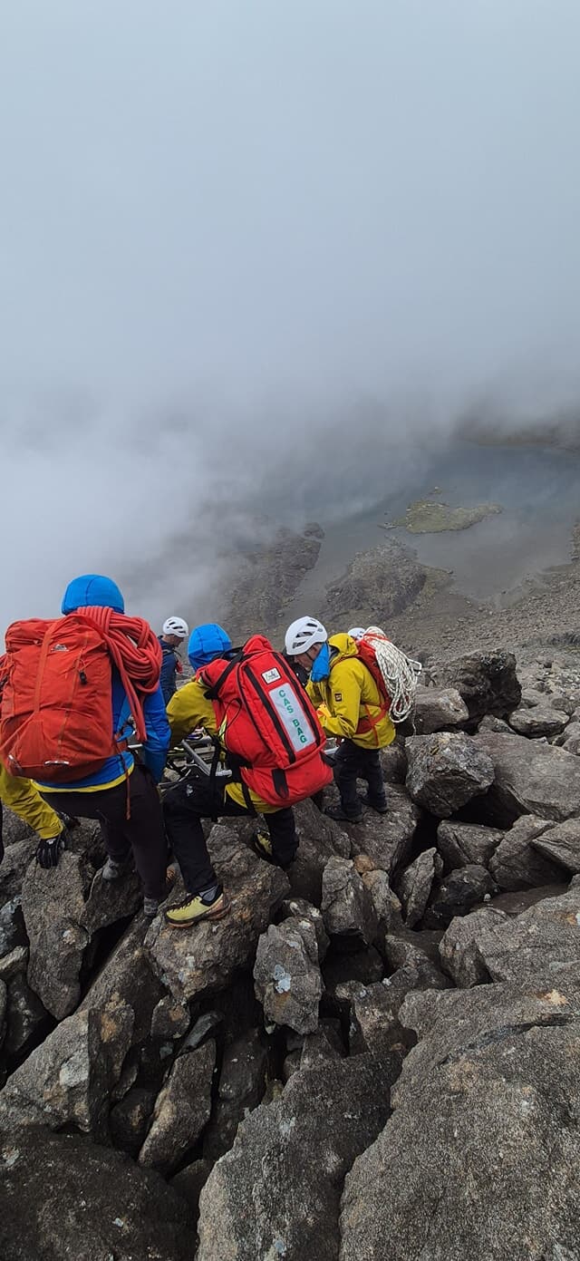 Team members assessed and treated the climber for multiple injuries before he was stretchered to safer ground.