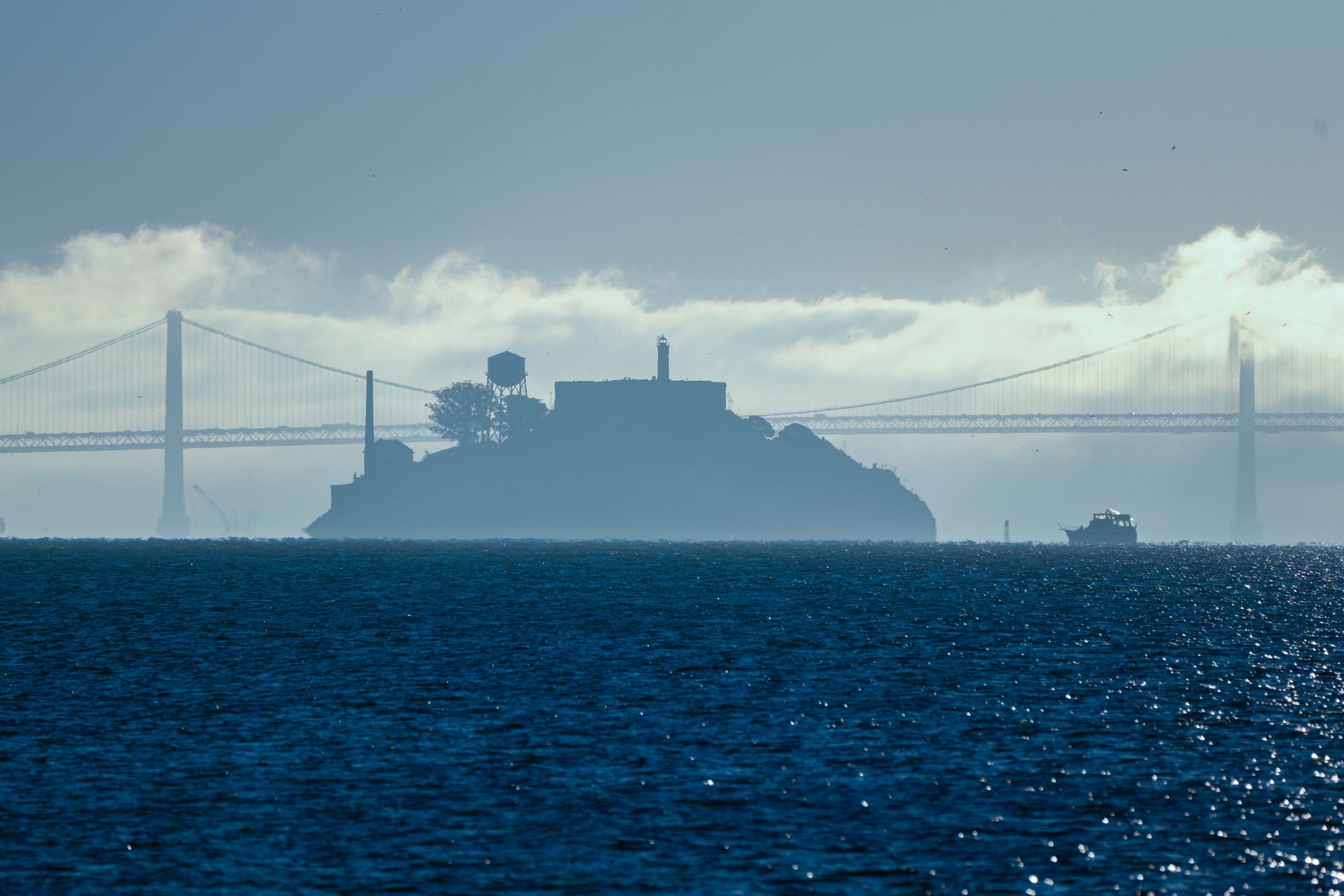 A boat makes its way toward Alcatraz Island with the San Francisco-Oakland Bay Bridge in the background (AP)